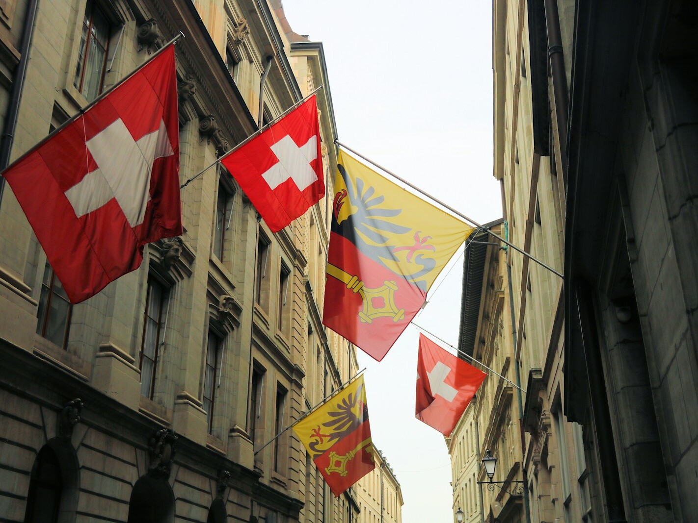 red white and yellow flags on flag pole